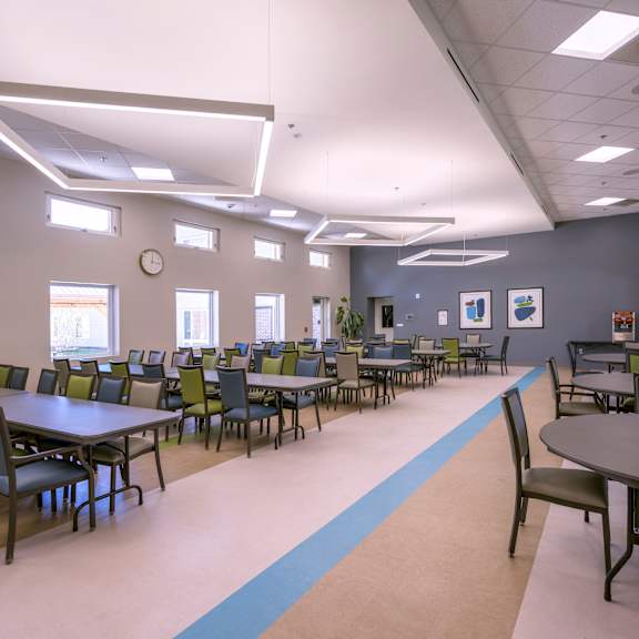 a room with tables and chairs arranged in rows.