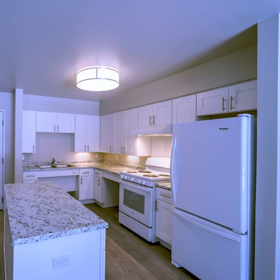a kitchen with white appliances and cabinets.