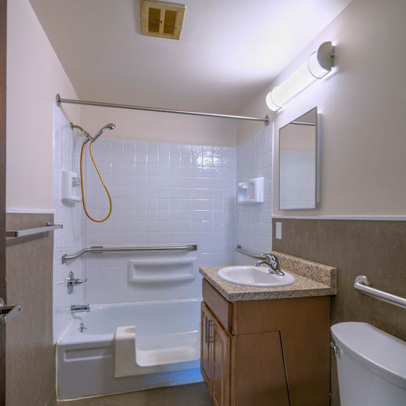 a white toilet sits next to a sink in a small bathroom.