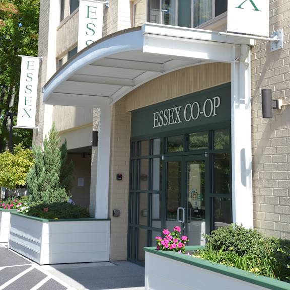 the entrance to the essex co-op building is framed by two banners.