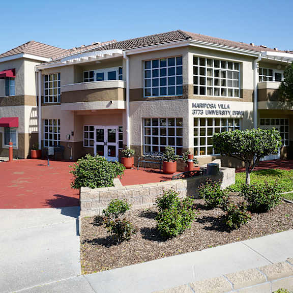 a building with the sign "harrisburg villa 3723 university drive" is shown.
