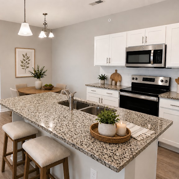 a kitchen with granite countertops and white cabinets.