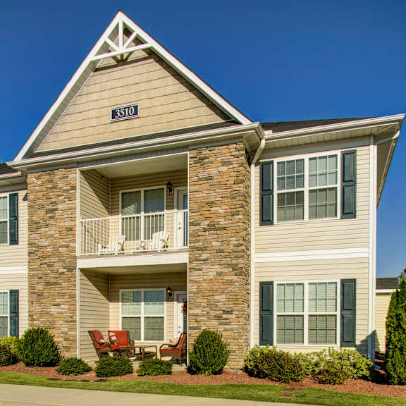 a two-story house with a balcony and a number 3510 on the front.