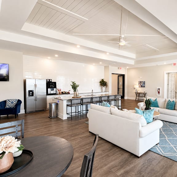 a spacious living room with a white couch and a coffee table.