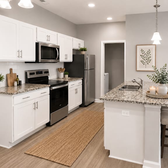 a kitchen with white cabinets and a granite countertop.