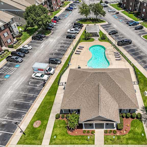 a swimming pool is located in the middle of a parking lot.