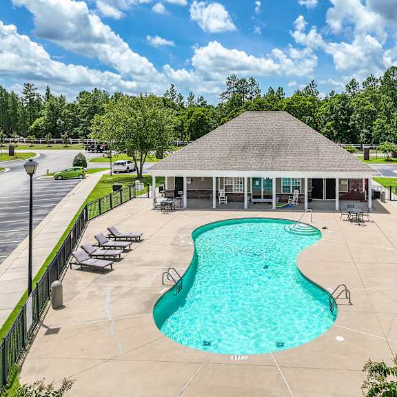 a pool with a building behind it.