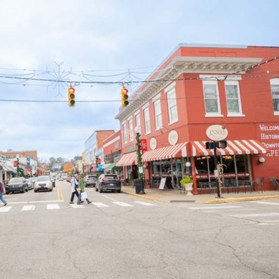 a street scene with a red building on the right.