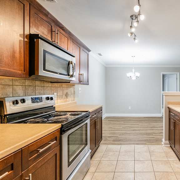 a kitchen with wooden cabinets and stainless steel appliances.