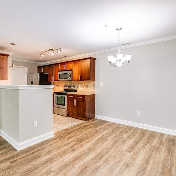 a kitchen with wooden floors and a white door.