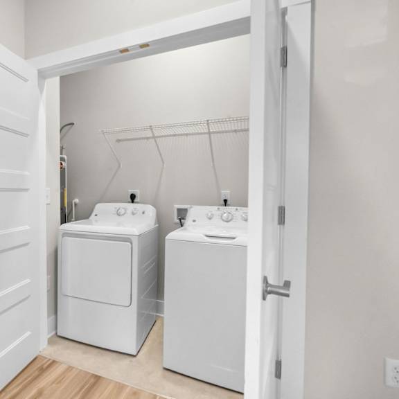 a white laundry room with a washer and dryer.