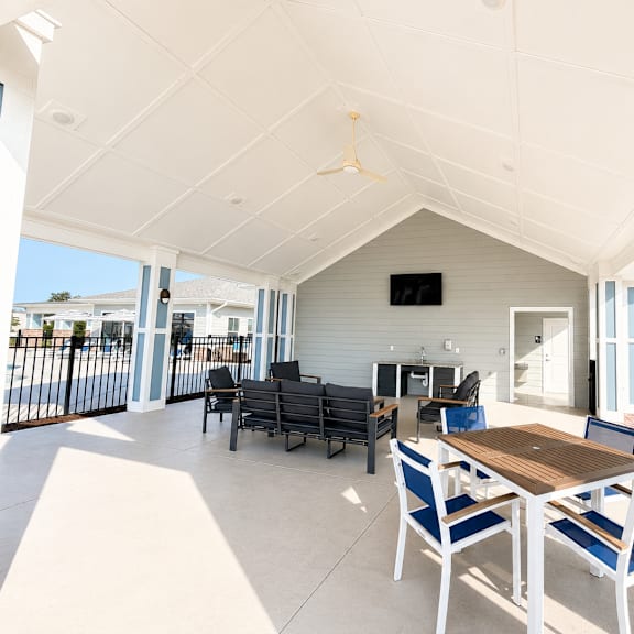 a patio with a table and chairs is shown.