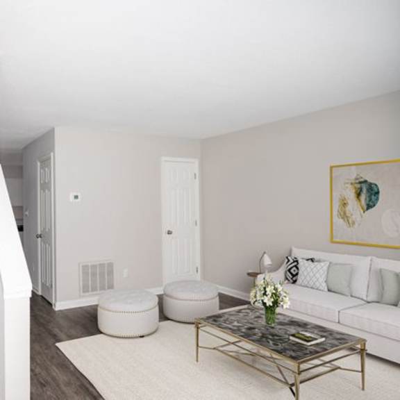 a living room with a staircase leading to the upper floor.