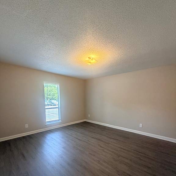 a small window in a room with a wooden ceiling.
