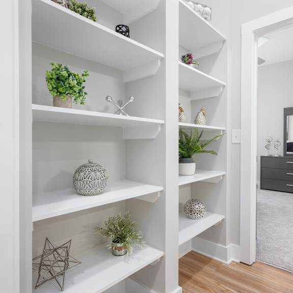 a white shelf with various decorative items on it.