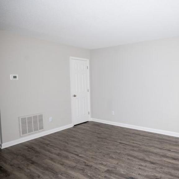 a room with a white door and a window with blinds.