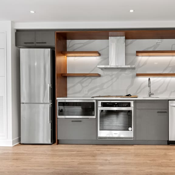 a modern kitchen with stainless steel appliances and wooden accents.