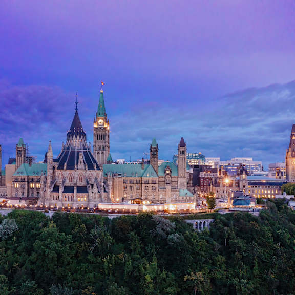 a large, ornate building with a green roof is the focal point of the image.