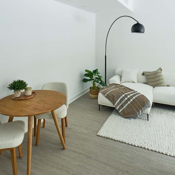 a living room with a white couch and a wooden table