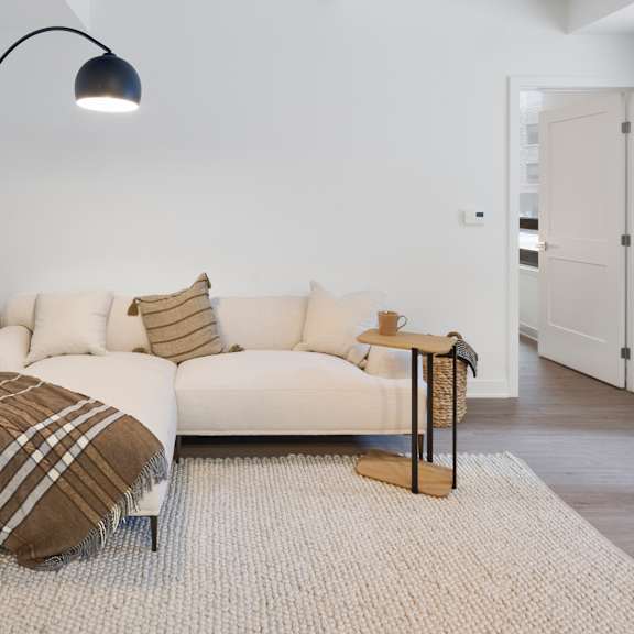 a living room with a couch and a lamp