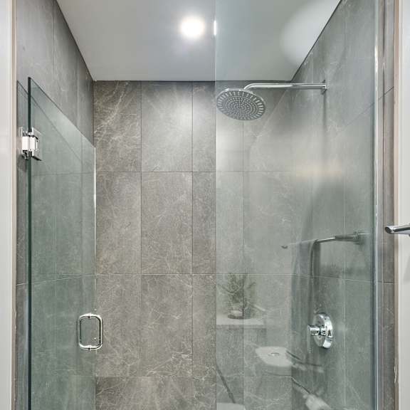 a shower with a glass door in a bathroom