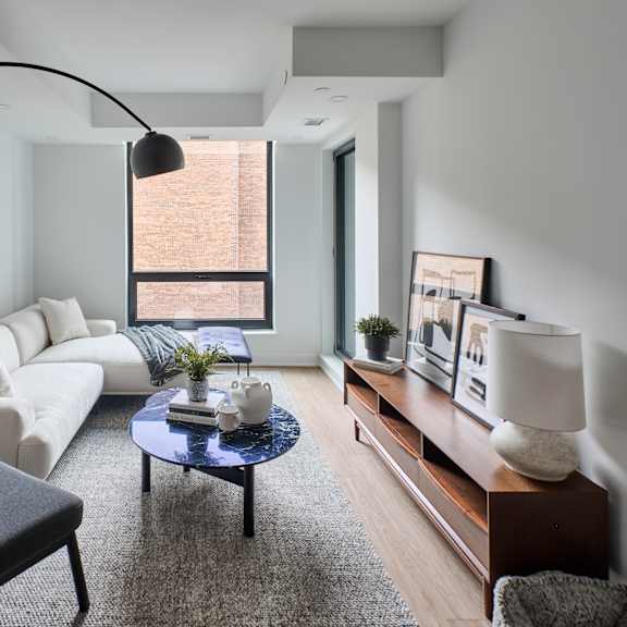 a living room with a white couch and a coffee table
