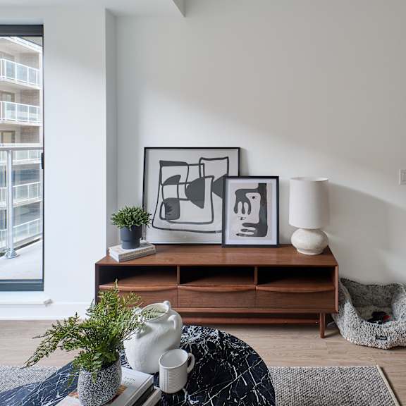 a living room with a couch and a table and a window