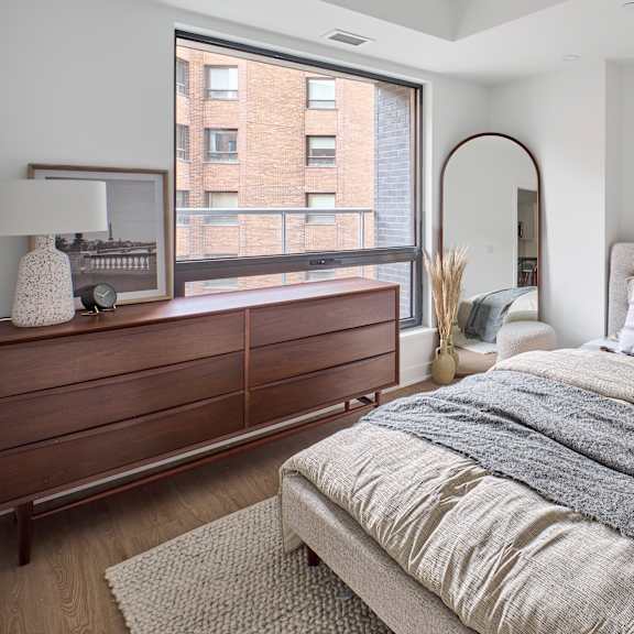 a bedroom with a bed and a large window