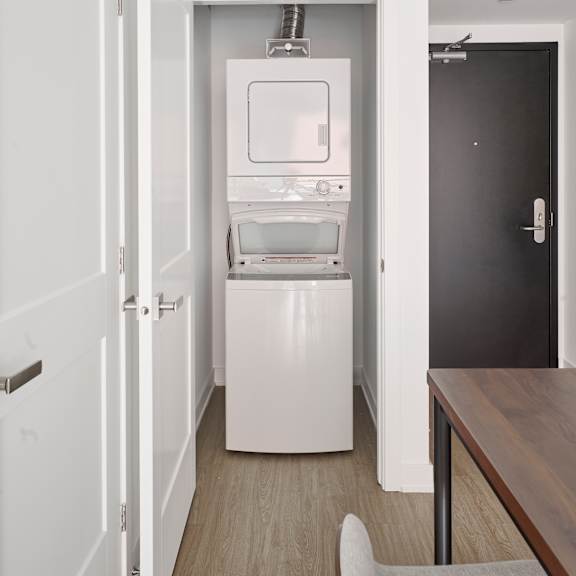 a small room with a refrigerator and a washing machine in it