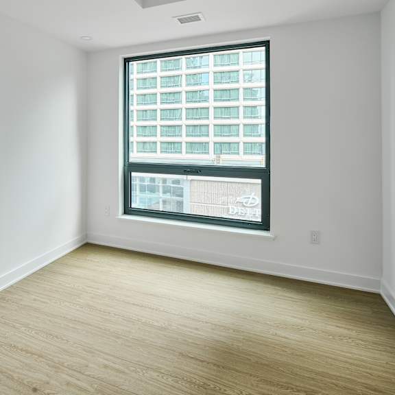 an empty room with white walls and a window