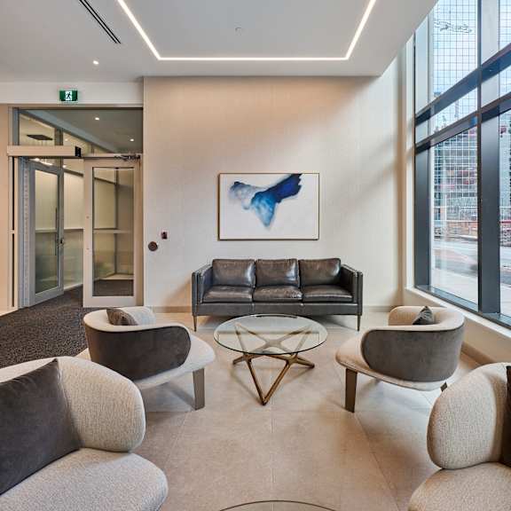 a living room with couches and chairs and a table