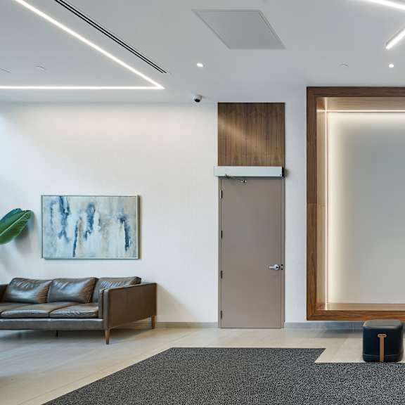 a large empty frame in a room with a couch and elevators