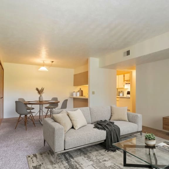 a living room with a grey couch and a coffee table.