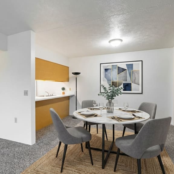 a dining room with a white table and grey chairs.