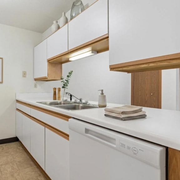 a kitchen with white appliances and wooden accents.