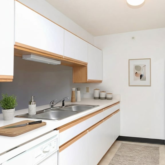 a kitchen with white cabinets and a white fridge.