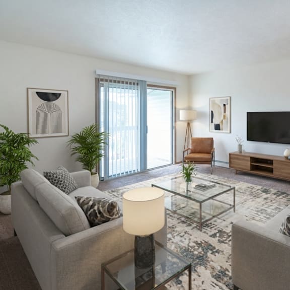 a living room with two grey couches, a glass coffee table, and a flat screen tv.