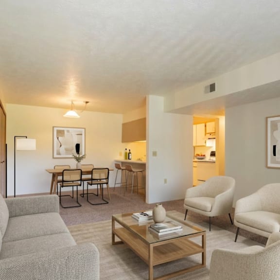 a living room with a grey sofa, two chairs and a coffee table.