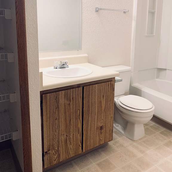 a small bathroom with a sink toilet and shower