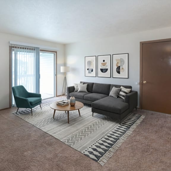 a living room with a grey sofa, a green chair, a wooden coffee table, and a rug.