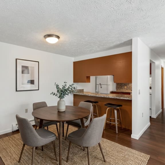 a dining room with a table and chairs.