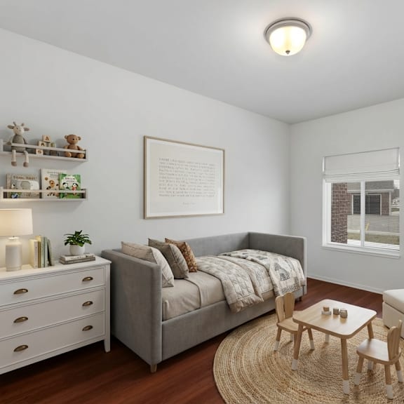a cozy bedroom with a grey bed, a white dresser, a wooden coffee table, and a beige armchair.