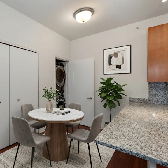a dining room with a round table and chairs.