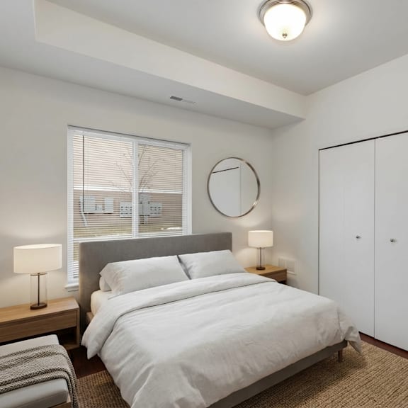 a bedroom with a bed, nightstands, and a window.