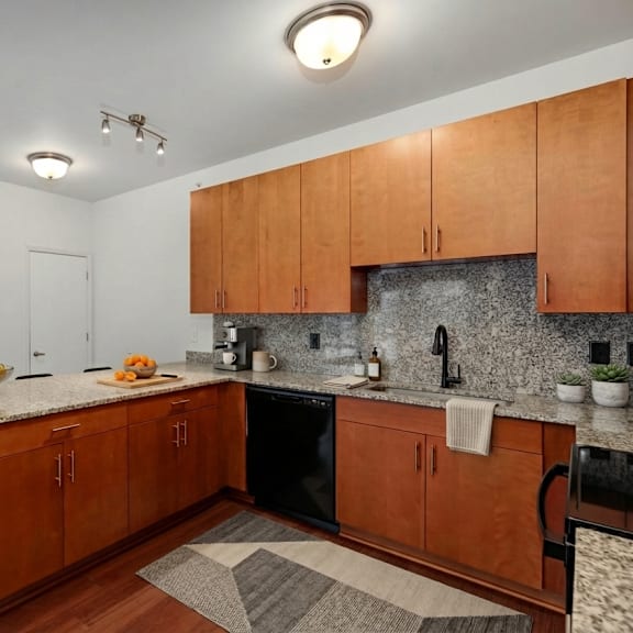 a kitchen with wooden cabinets and a granite countertop.