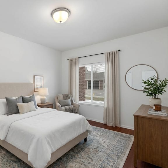 a bedroom with a large bed and a window with curtains.