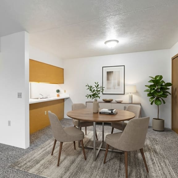 a dining room with a round table and chairs.