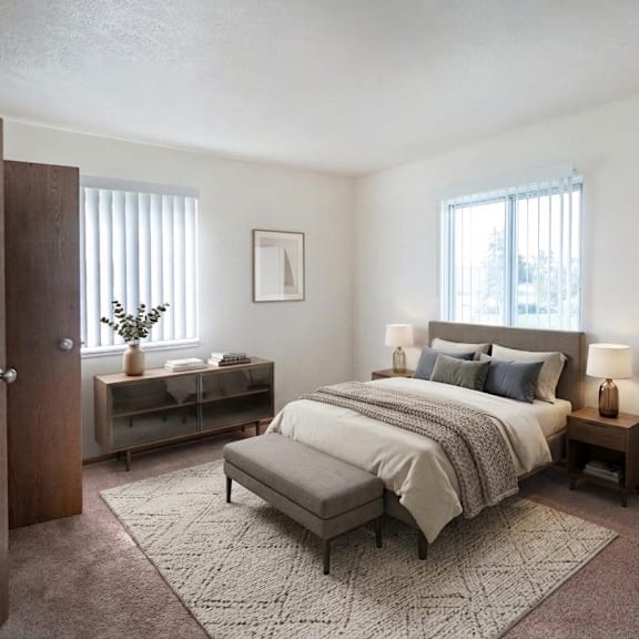 a bedroom with a bed, chair, and nightstands.