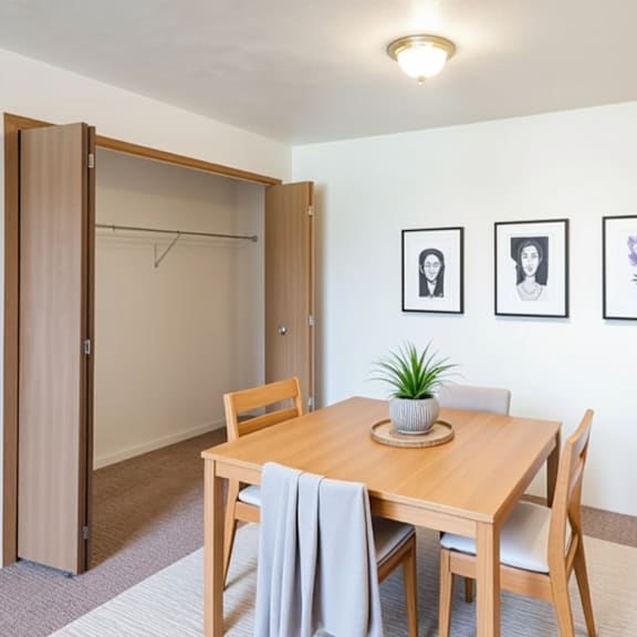 a dining room with a table and chairs.