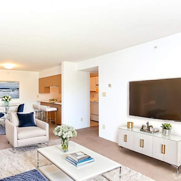 a living room with a white couch and a coffee table.